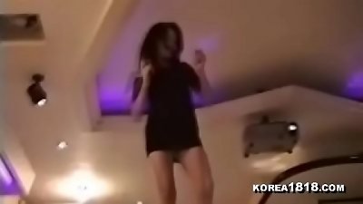 A sexy Korean dancer performs a striptease at night.