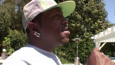 The big-boobed adult film star Lisa Ann faces Shorty Mac's huge black cock in a hardcore scene.