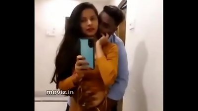 Woman in hotel room pleasures herself by playing with her breasts and fingering her vagina