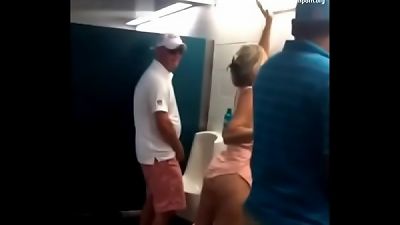 Older woman urinating in the restroom for men while intoxicated
