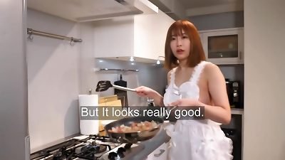 Full nipple view cooking rice with a naked apron